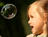 Little girl looking at bubble