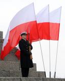 Soldier in front of the Polish flag